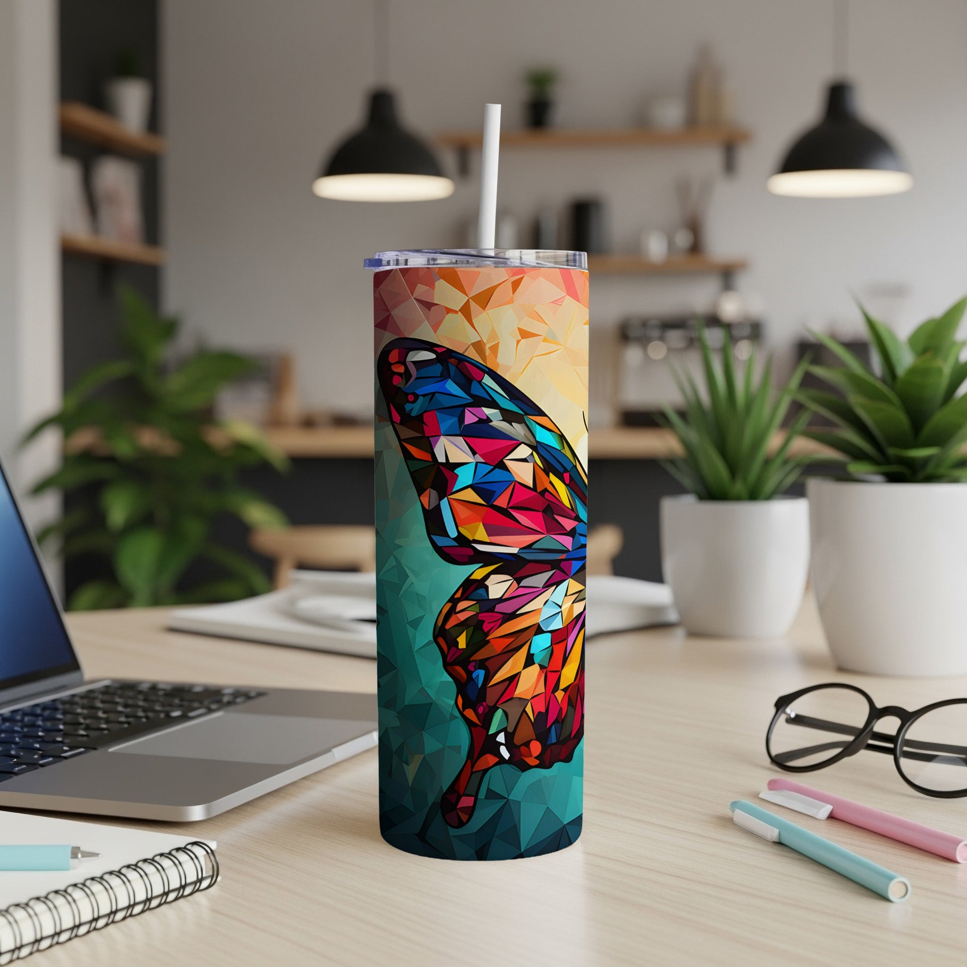 Geometric stained-glass butterfly pattern on a tall tumbler with a straw.