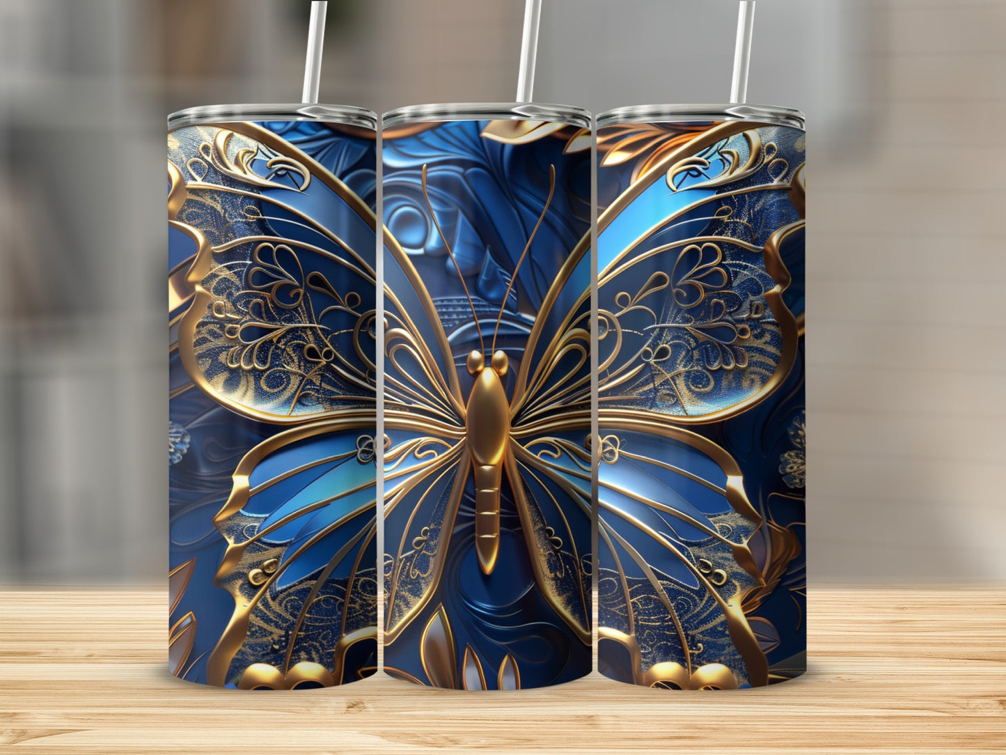 Three tall tumblers with ornate blue and gold butterfly designs.