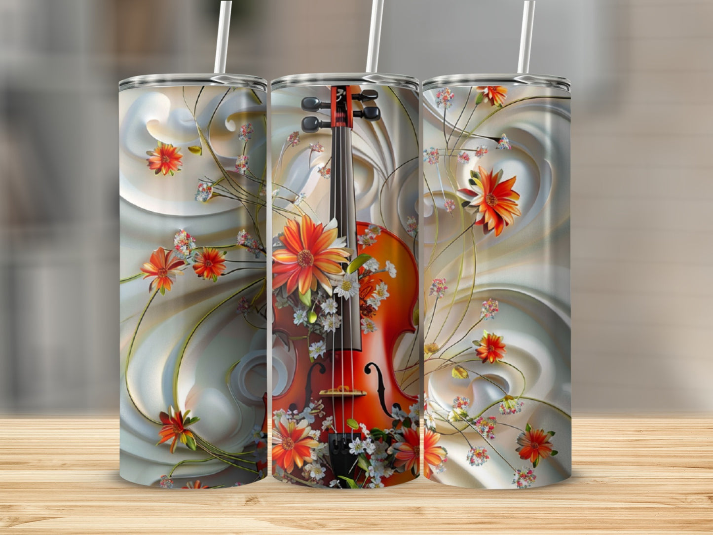 Violin and floral pattern on three tumblers with straws.