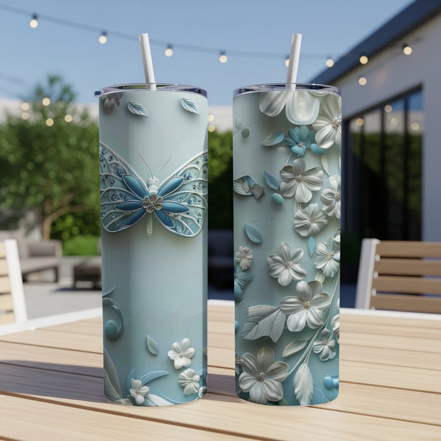 Two light blue tumblers with butterfly and floral embossed designs.