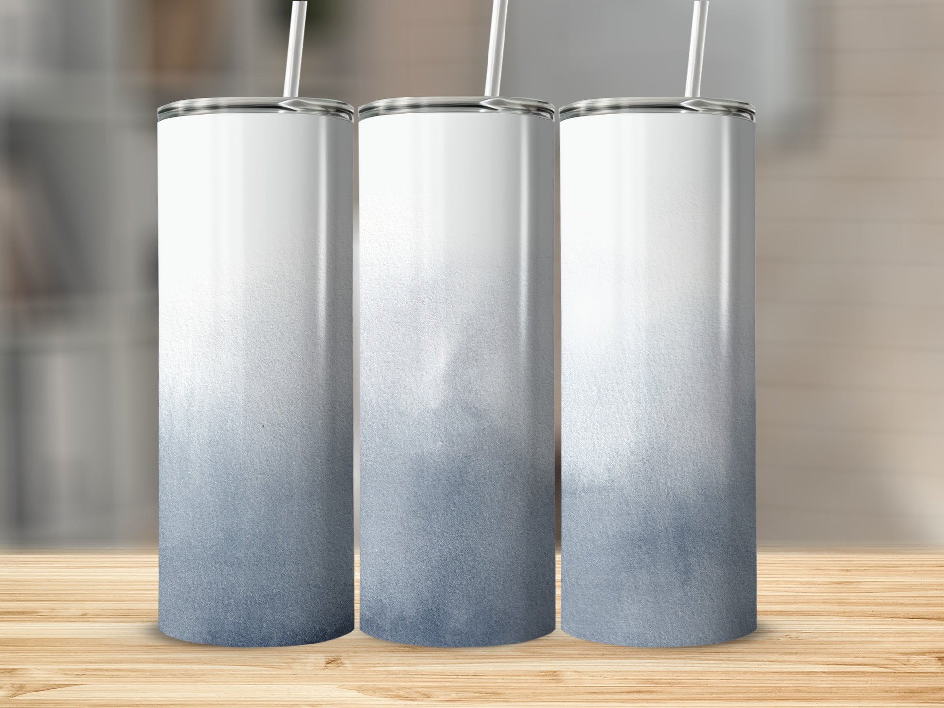 Three white tumblers with a blue watercolor fade design.