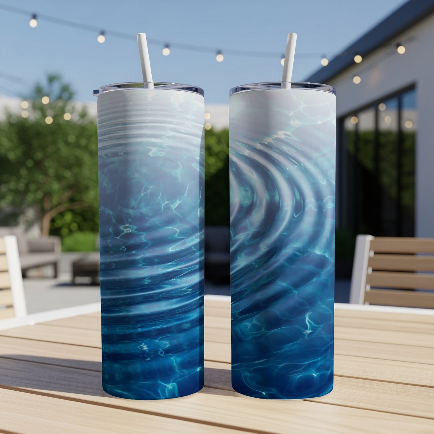 Two tumblers with rippling blue water design on a wooden table.