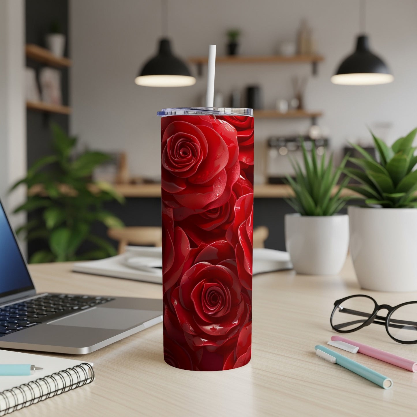 Red roses fill a skinny tumbler with a white straw.
