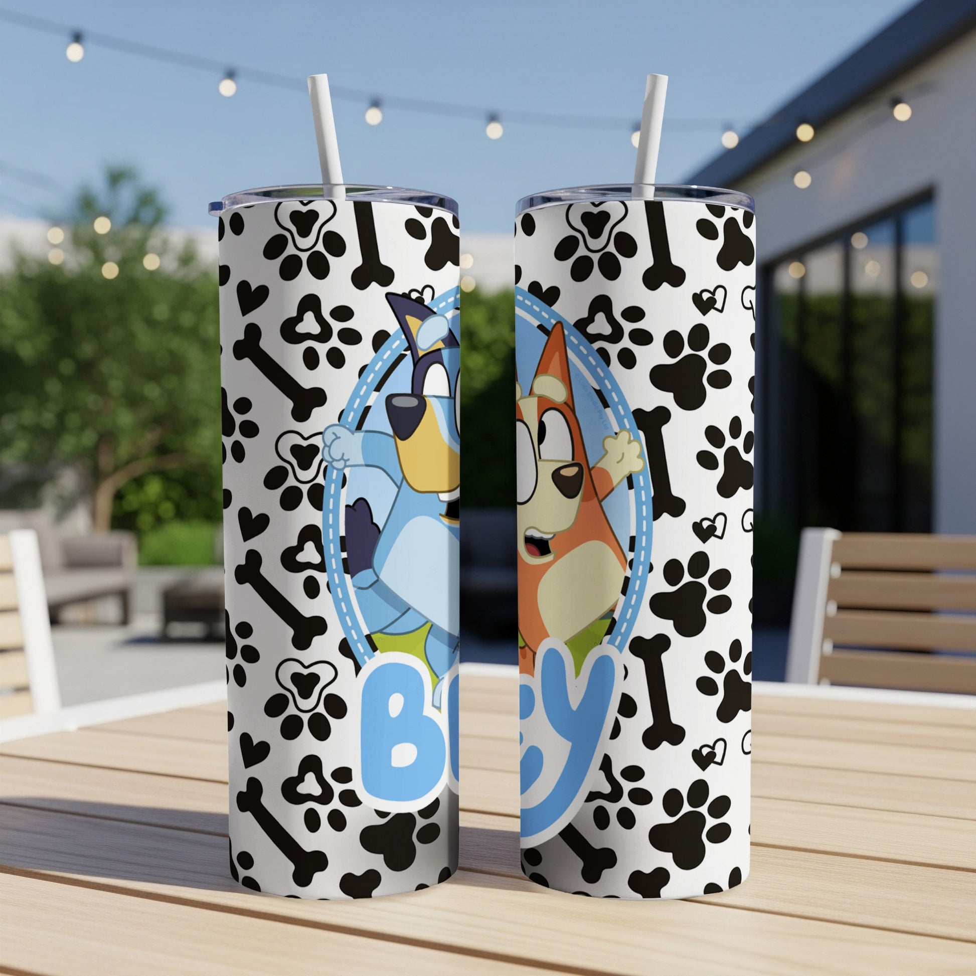 Bluey and Bingo characters on a blue and white paw print tumbler with straw.