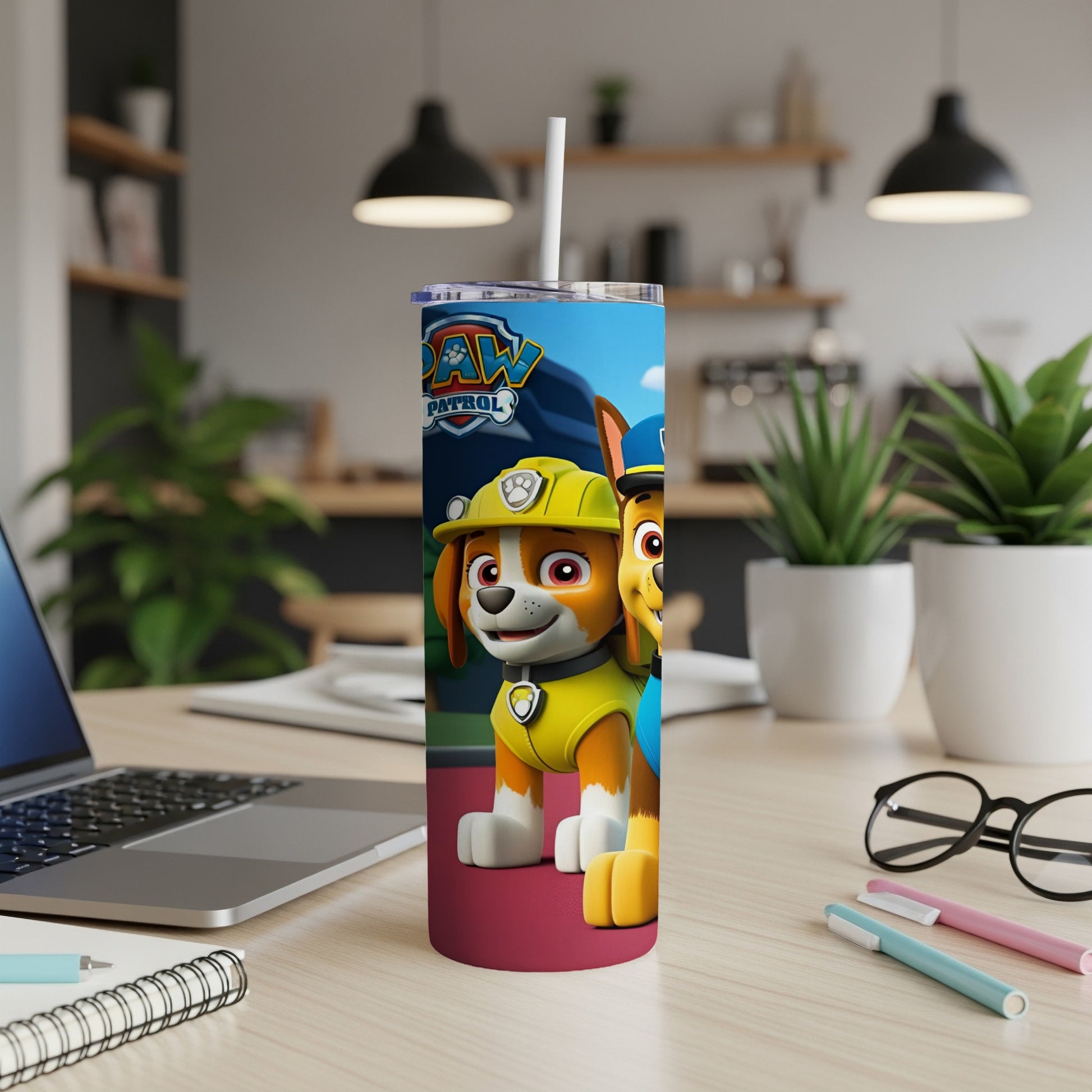 Chase and Marshall from Paw Patrol on a colorful tumbler with a laptop and desk supplies.