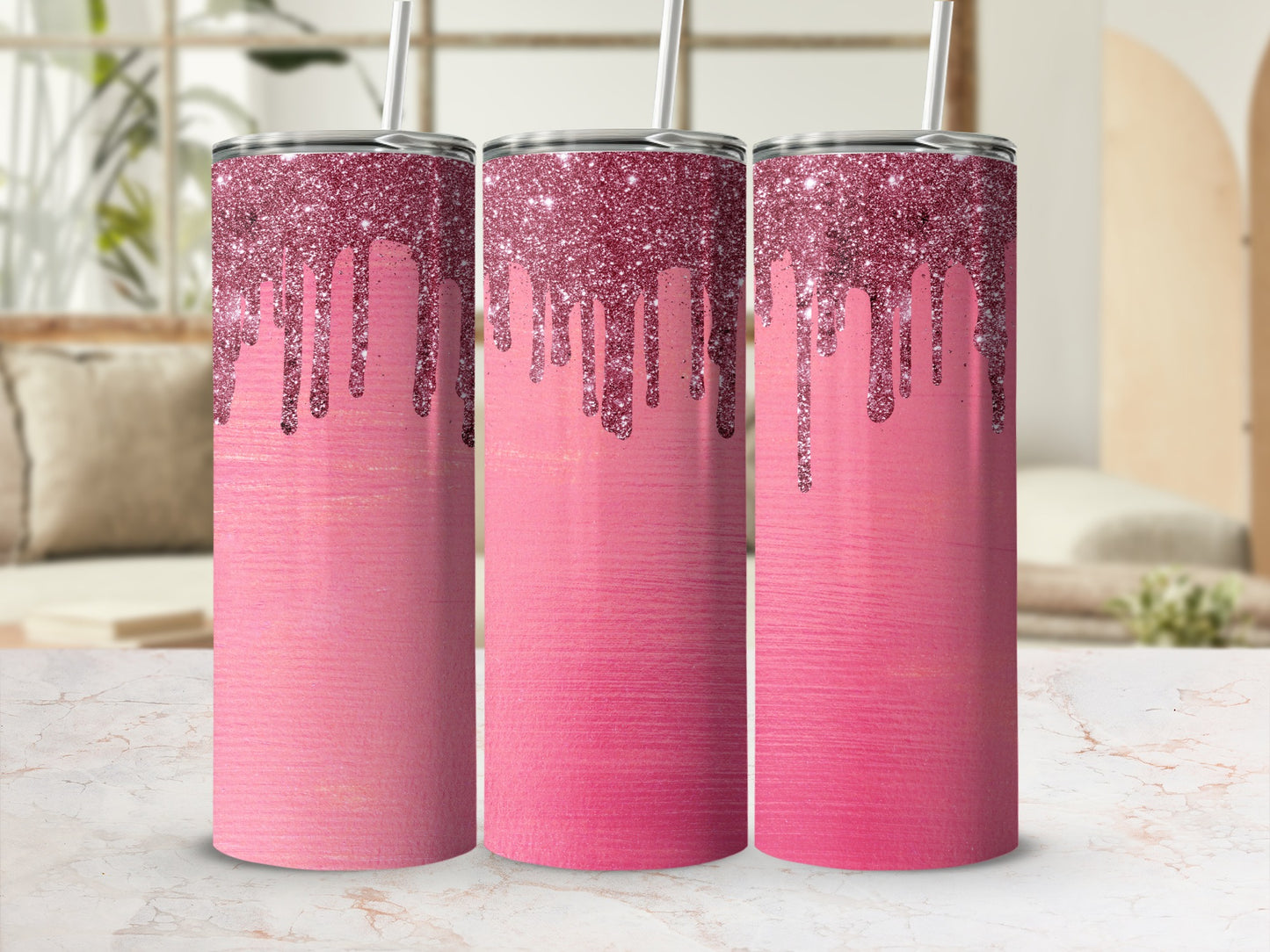 Three pink tumblers with dripping glitter design and metal straws.