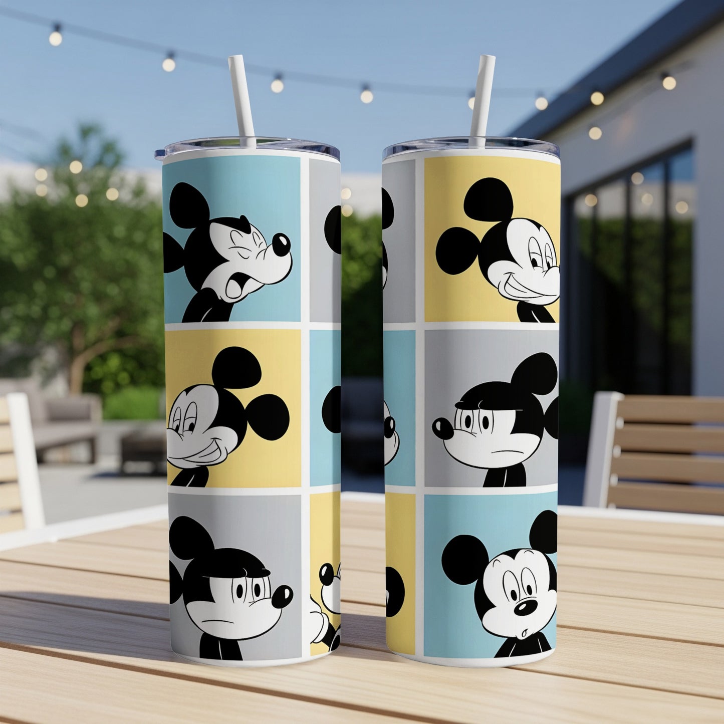 Mickey Mouse faces in colorful comic panels on two tall tumblers.