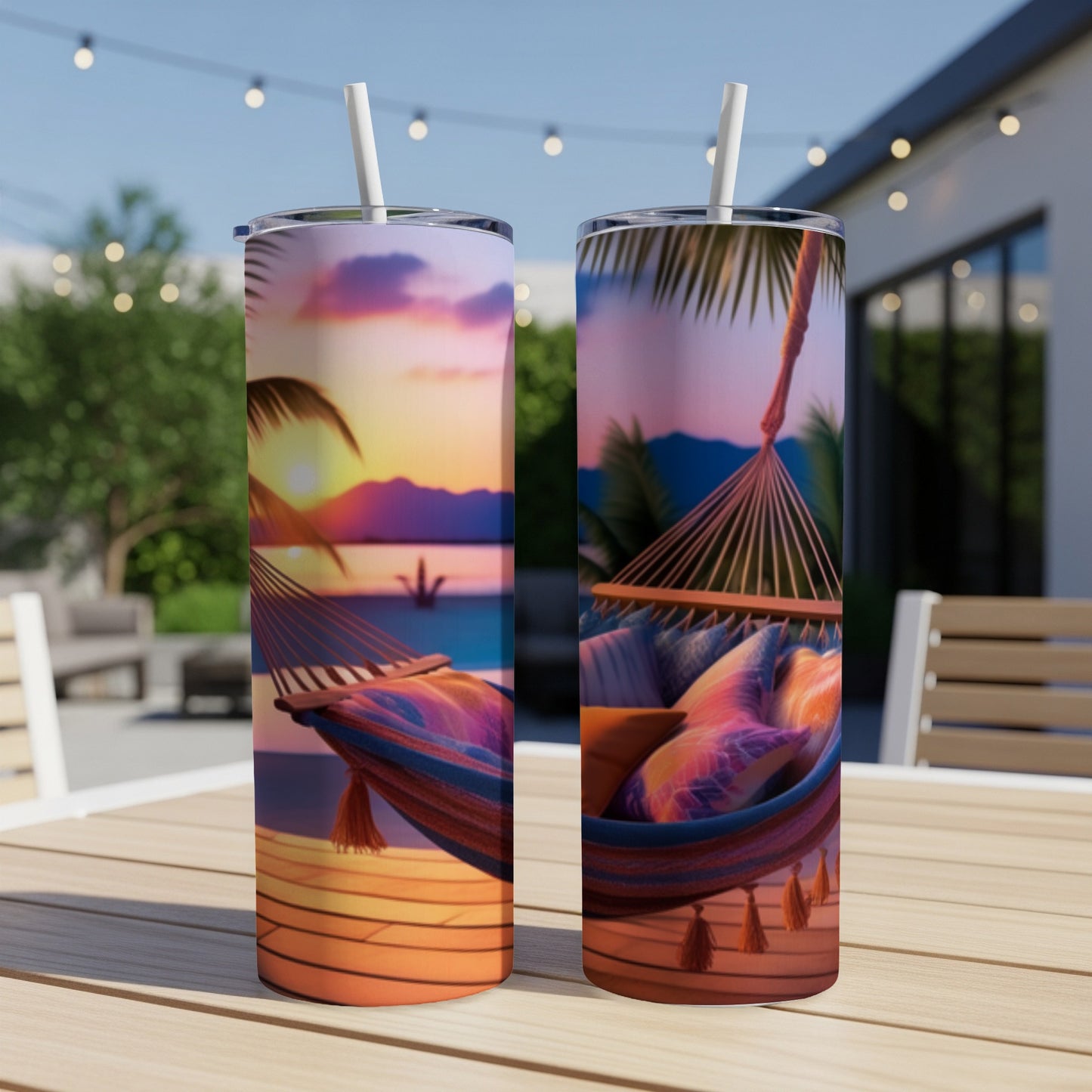Two tumblers with a tropical sunset hammock scene and colorful pillows.