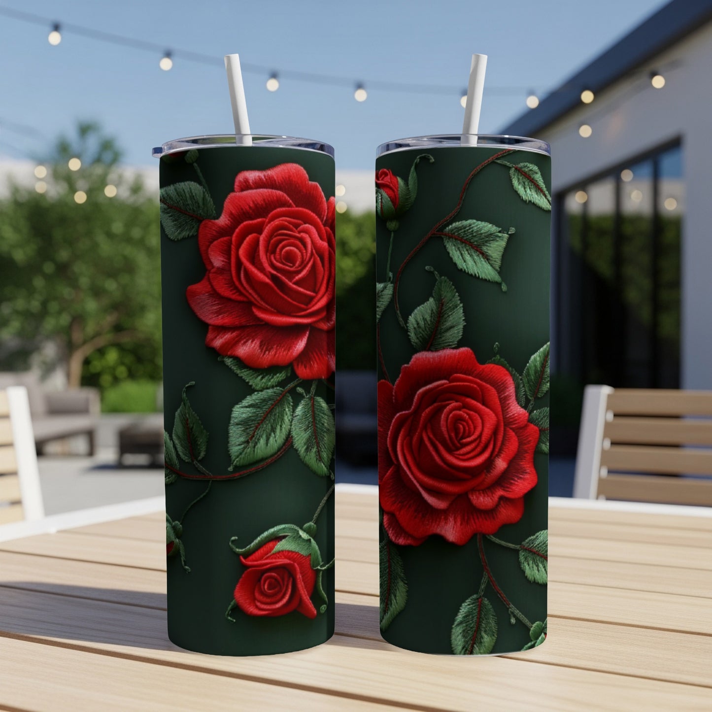 Two tumblers with red embroidered roses on a dark green background.