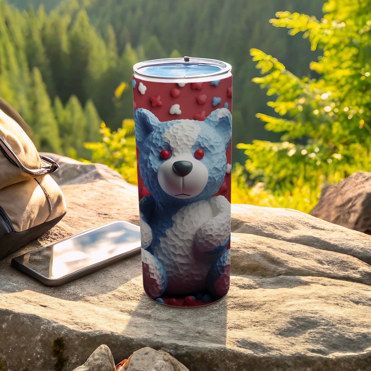 Tumbler with a blue and white teddy bear pattern on a rock.