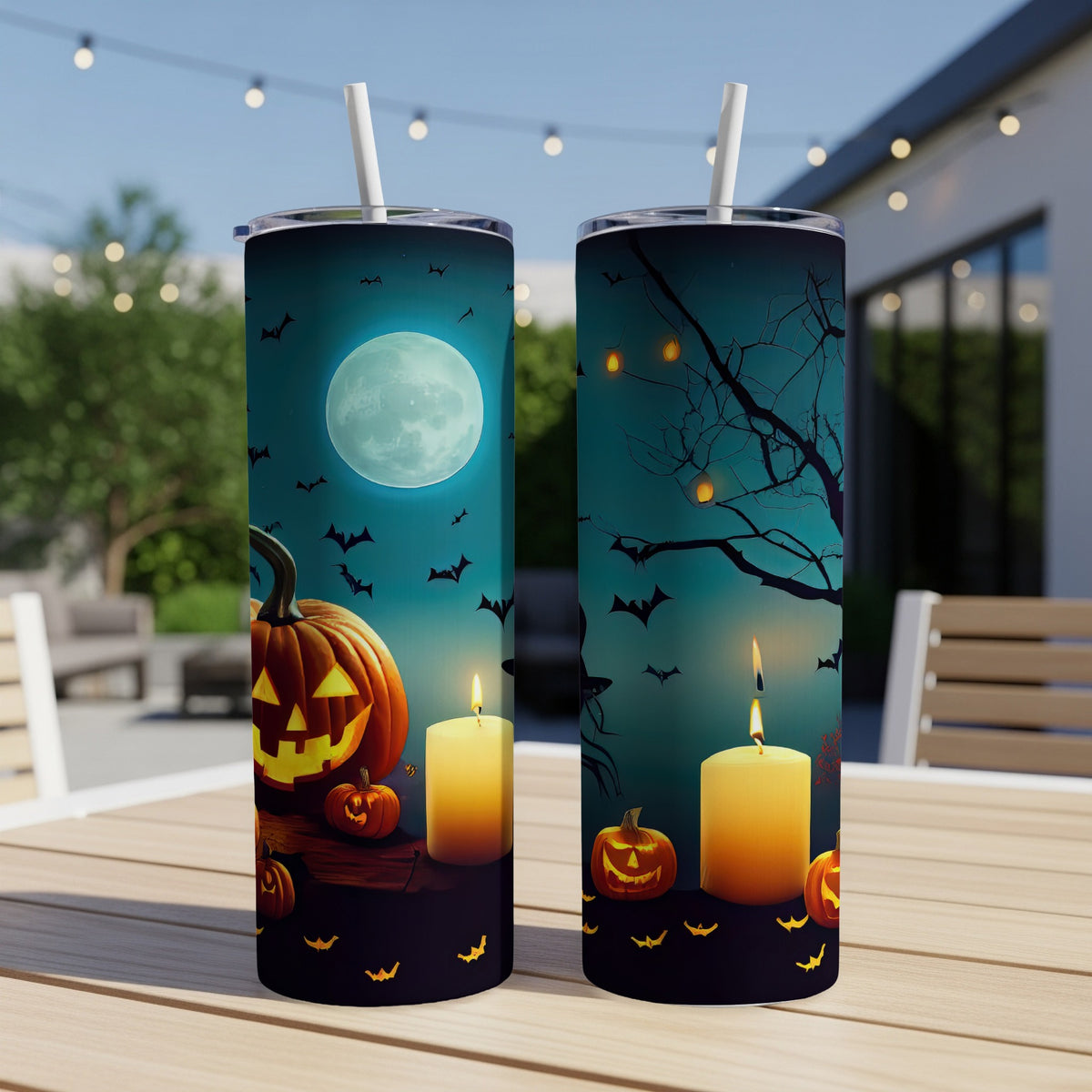 Two Halloween-themed tumblers with pumpkins, candles, and bats.