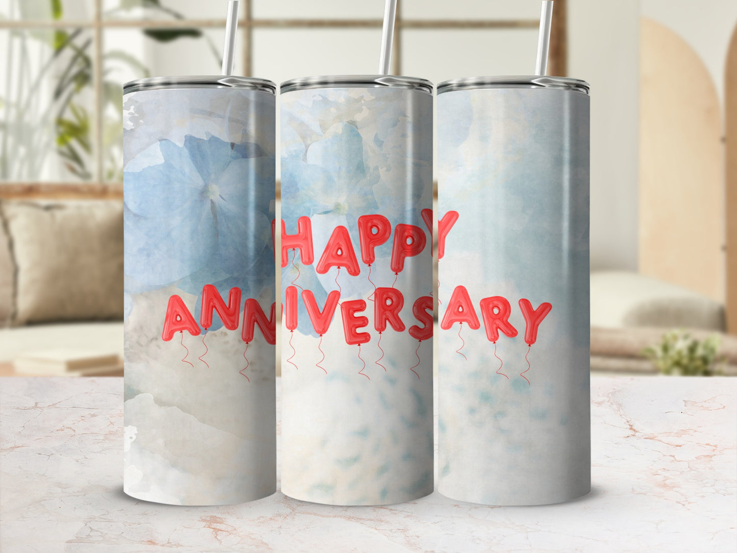 Three tumblers with red balloon letters spelling "Happy Anniversary" on a light background.
