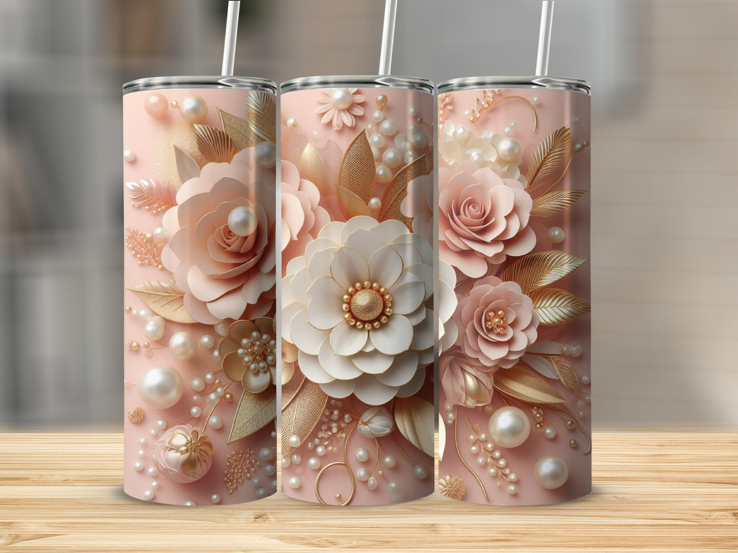 Three tall tumblers decorated with pink and gold floral and pearl designs.