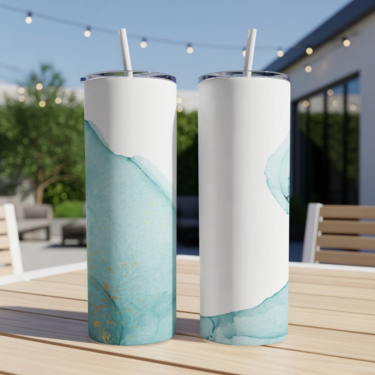Two tumblers with blue and gold watercolor design, one showing straw.