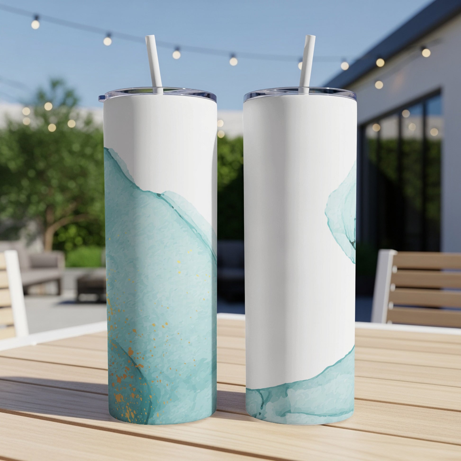 Two tumblers with blue and gold watercolor design, one showing straw.
