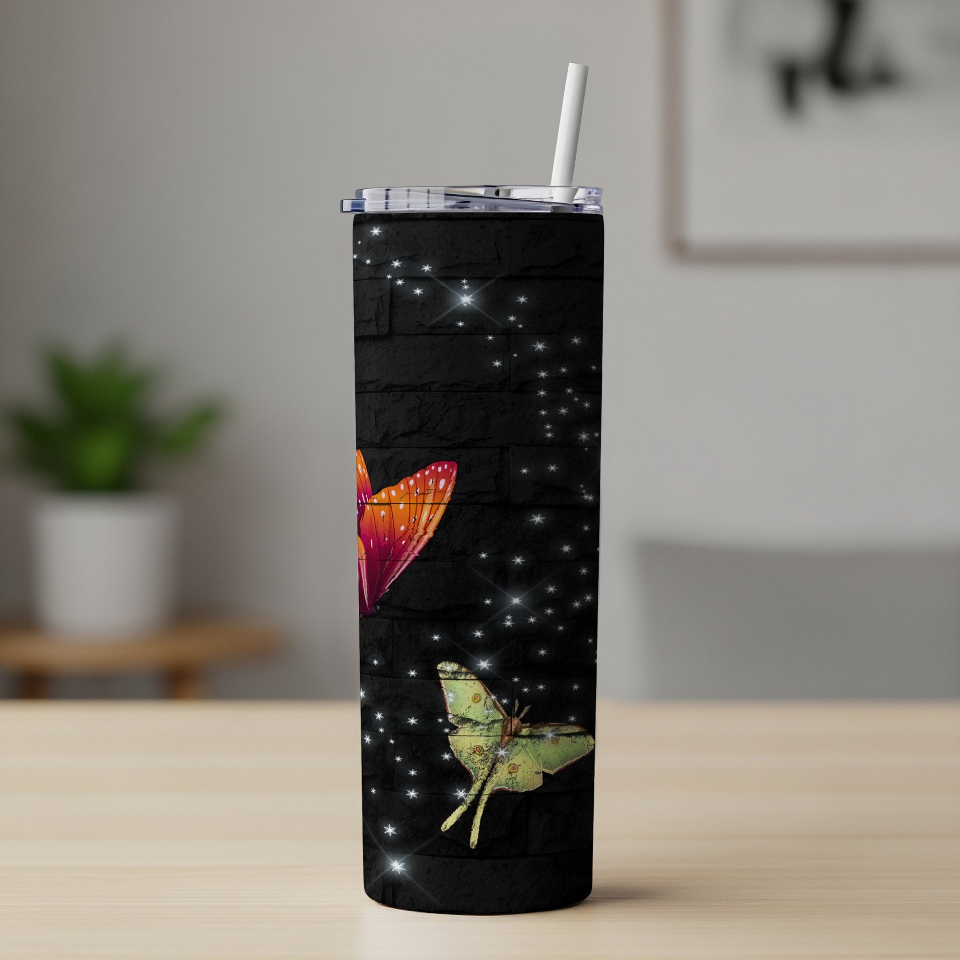 Black tumbler with white stars and colorful butterfly designs.