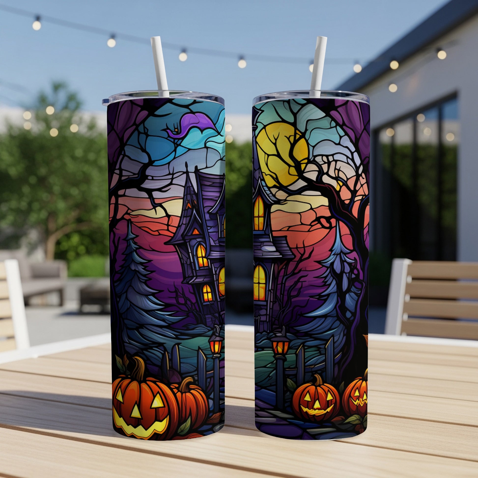 Halloween haunted house with pumpkins and moon design on two tumblers.