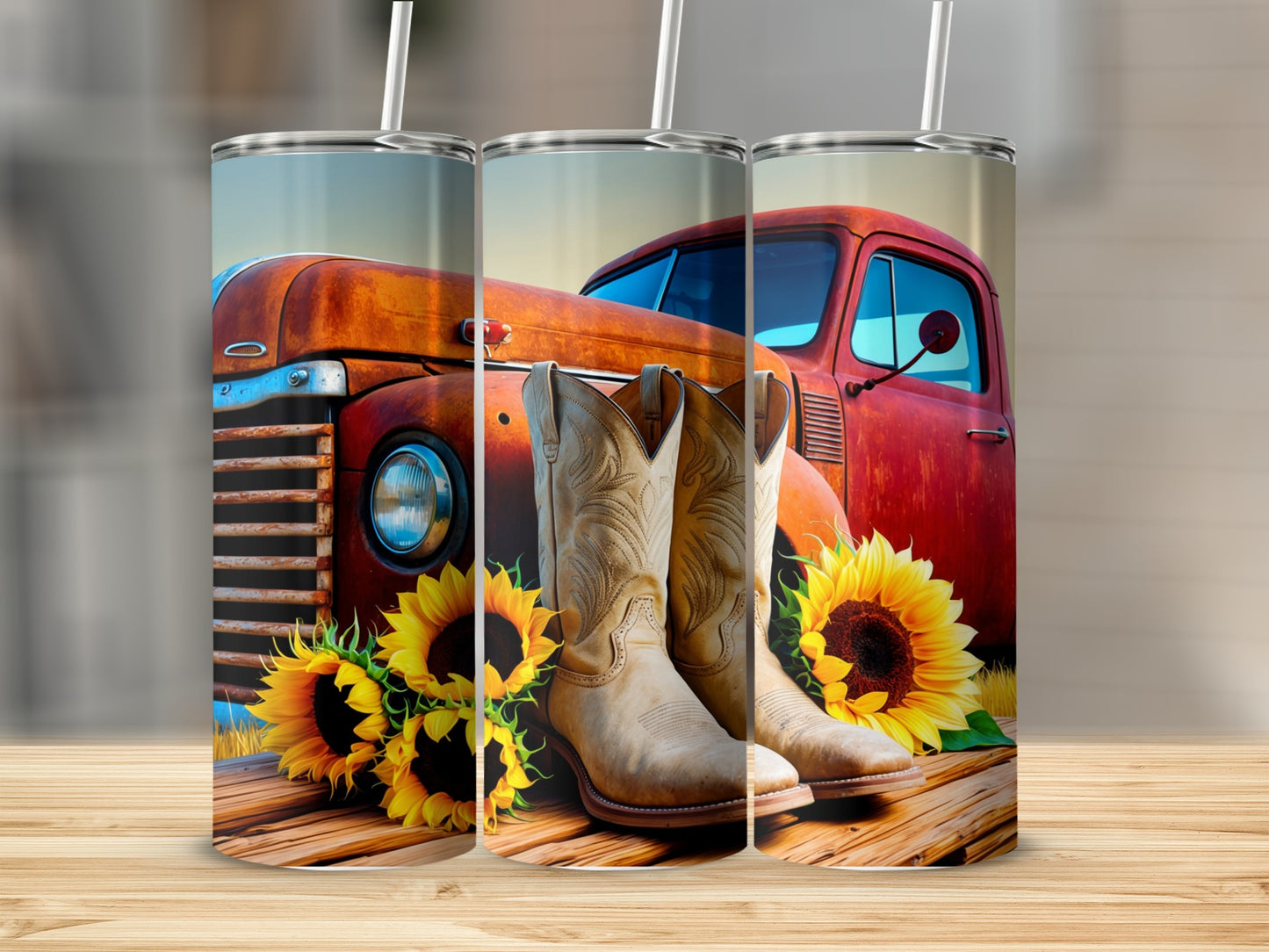 Cowboy boots and sunflowers rest on a wooden surface in front of a vintage truck.