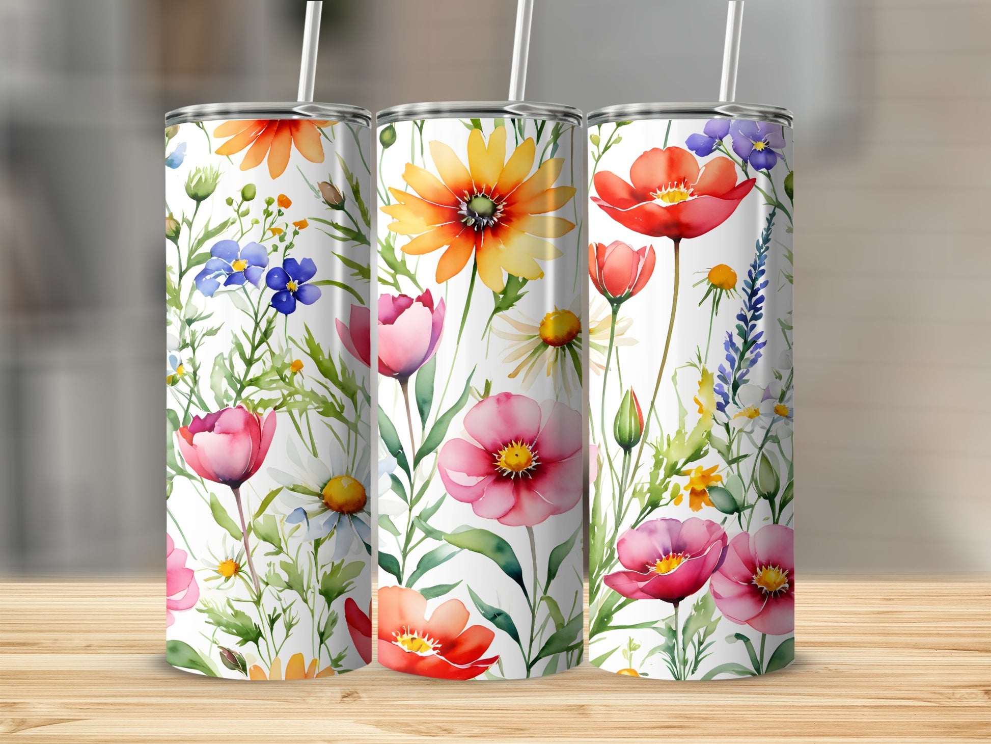 Three floral tumblers with colorful wildflowers, poppies, and daisies.