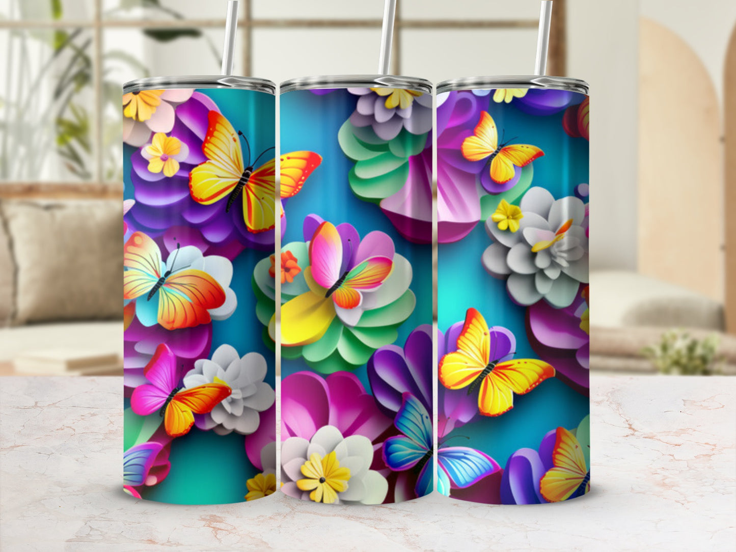 Three tumblers with colorful butterflies and floral designs.