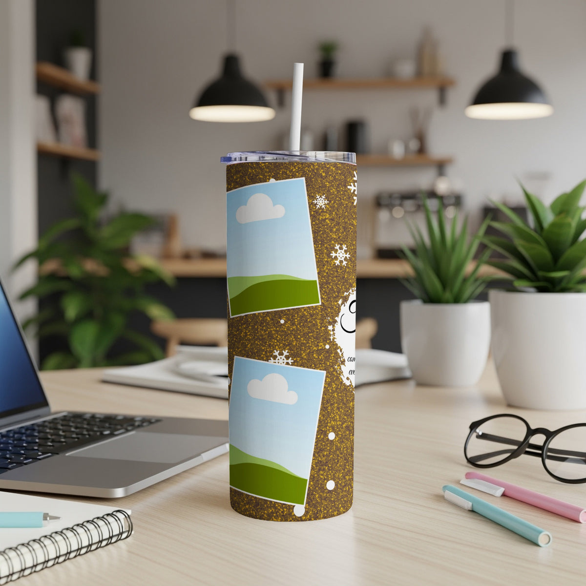 Glitter tumbler with photo slots and snowflakes, on a desk.