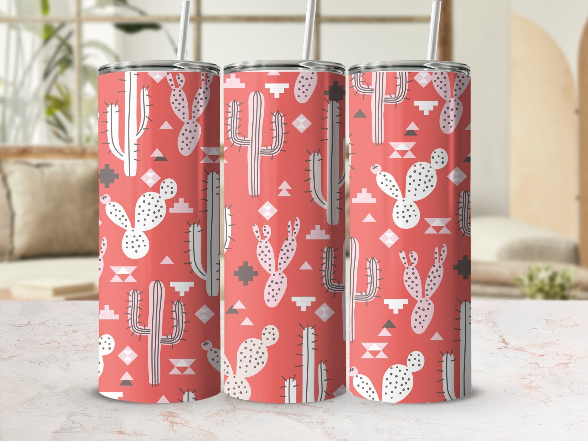 Three tumblers with a coral background and white cactus and geometric pattern.