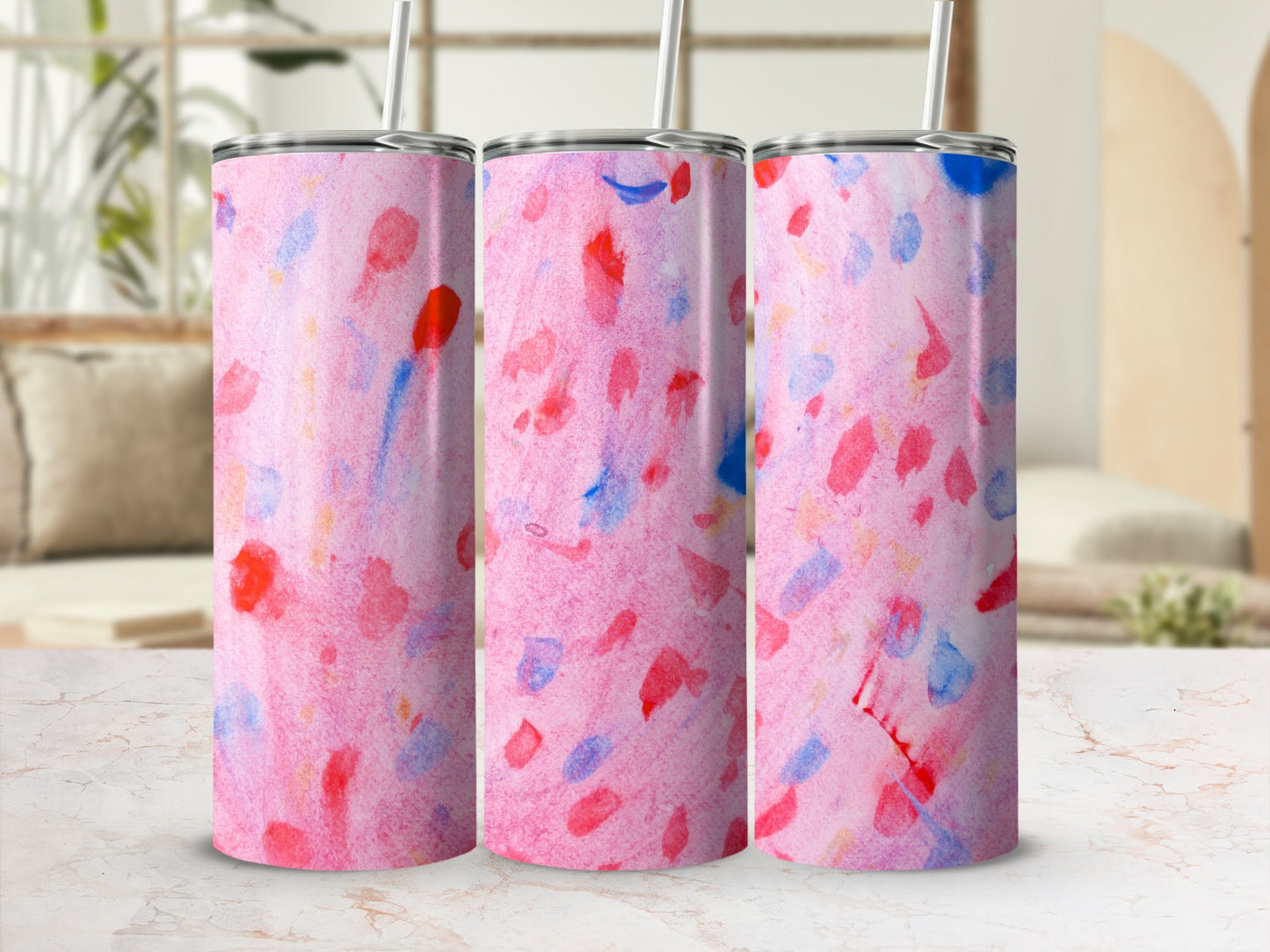 Three pink and blue abstract watercolor tumblers with straws.
