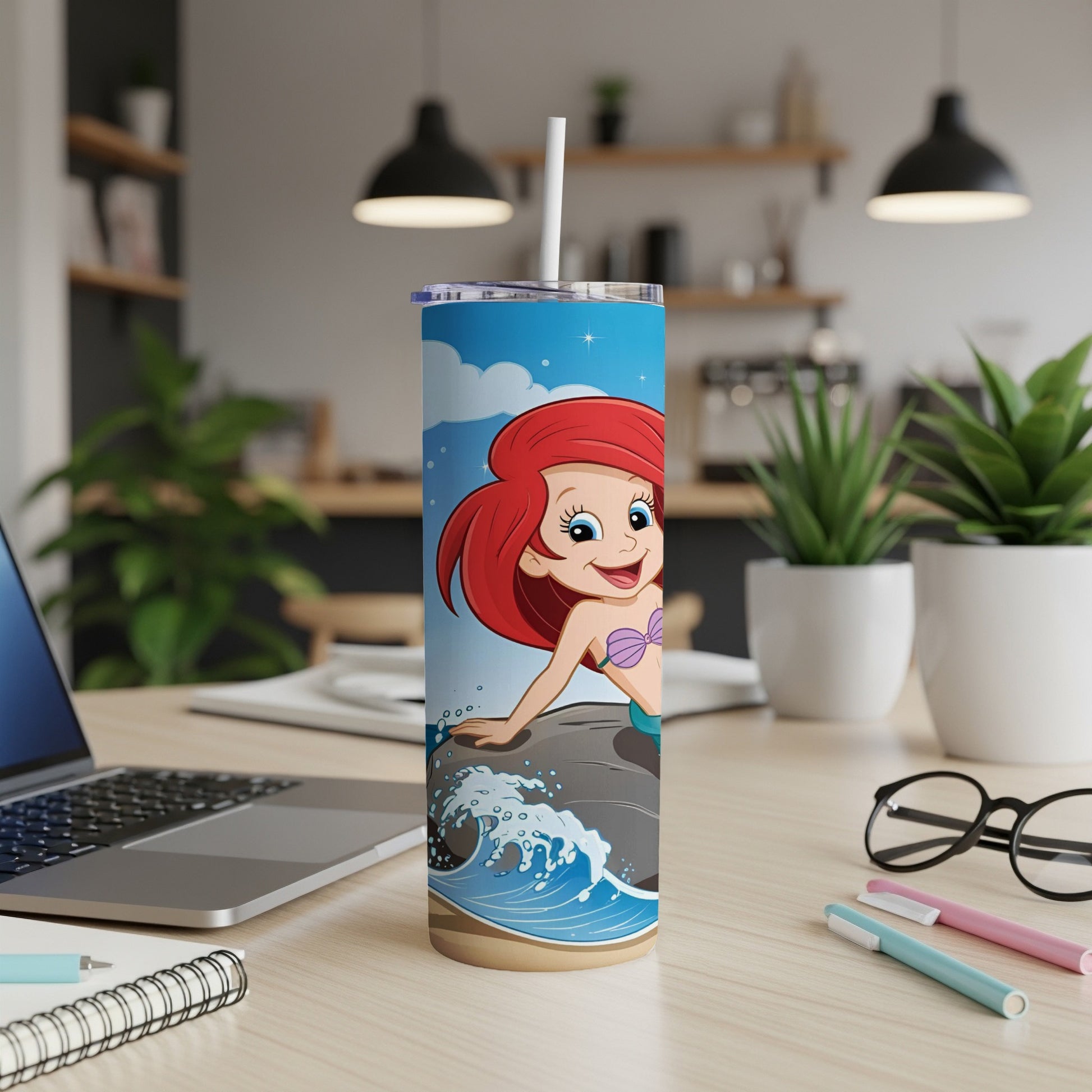 Ariel from The Little Mermaid on a rock with waves, on a blue patterned tumbler.