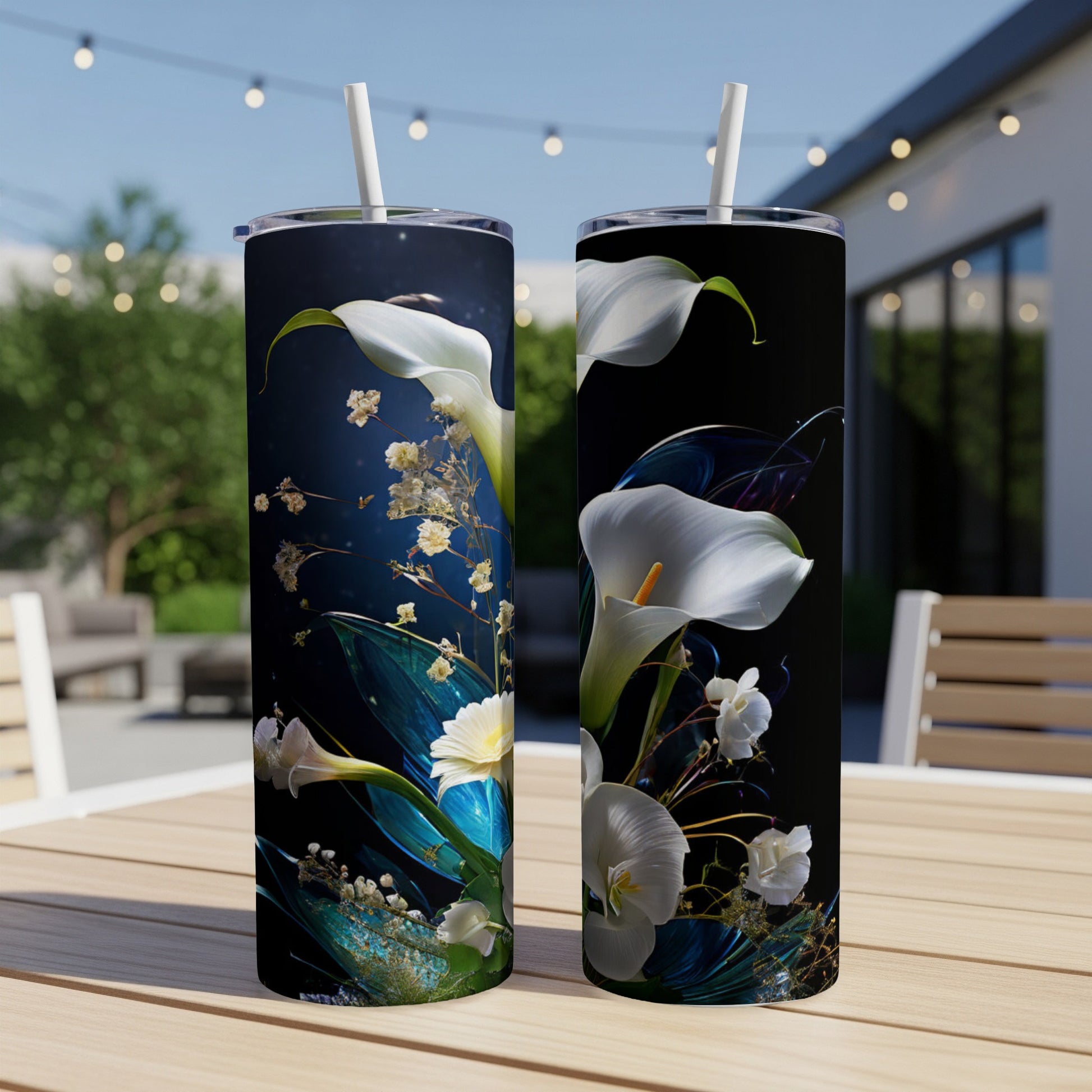 White calla lilies and delicate flowers adorn two tumblers on a wooden table.