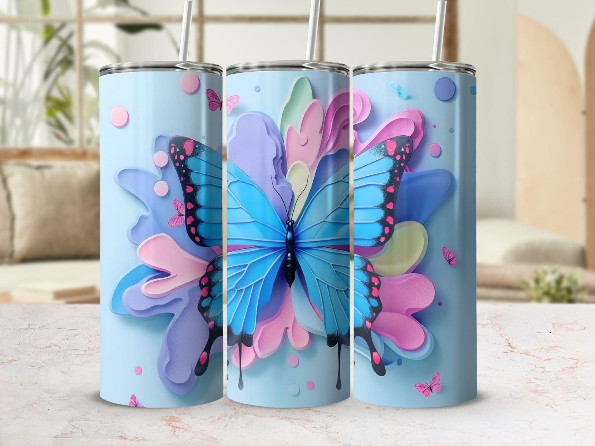 Blue butterfly design on three pastel blue tumblers with colorful floral accents.
