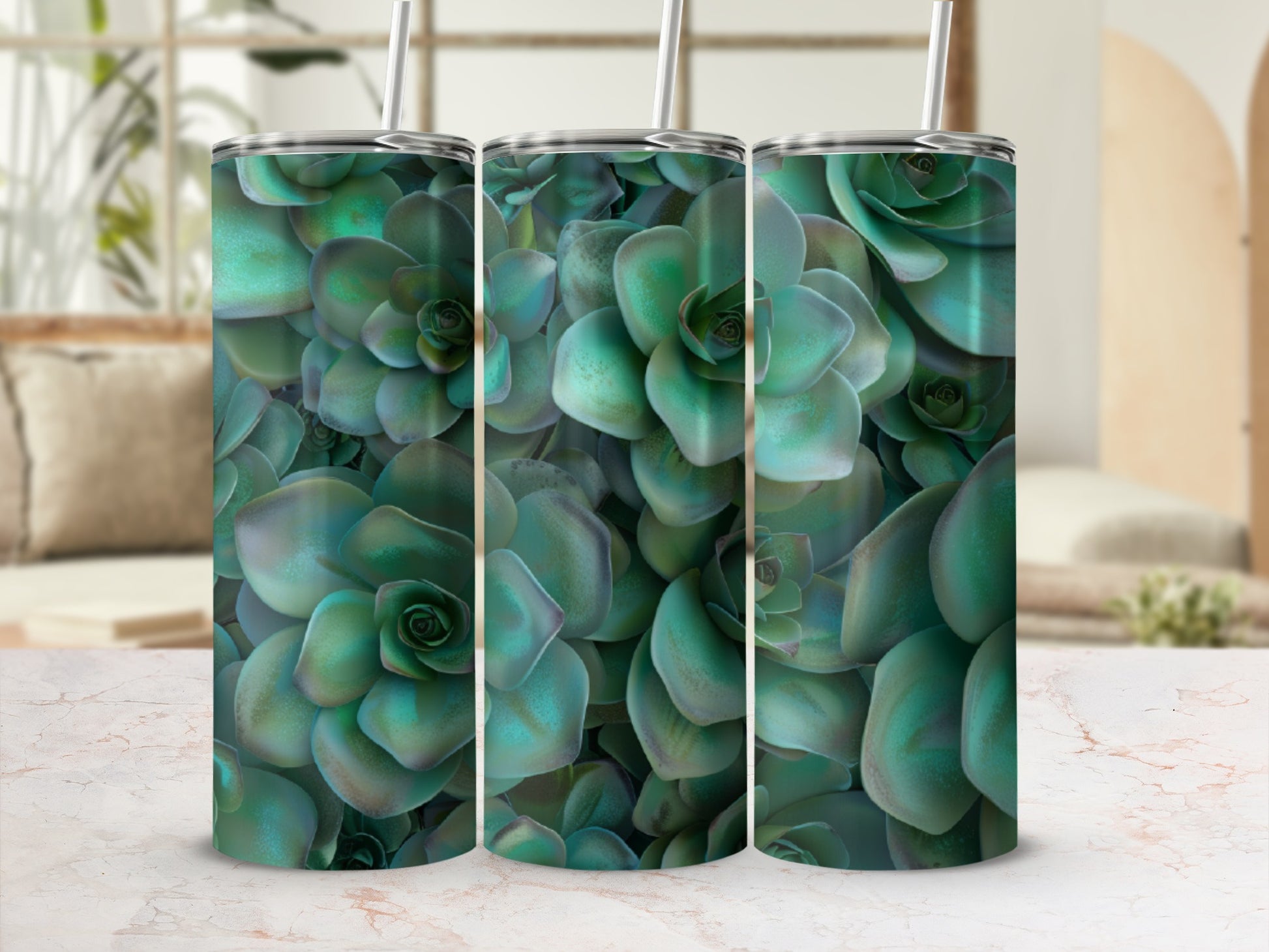 Three tumblers with a succulent plant pattern on a marbled surface.