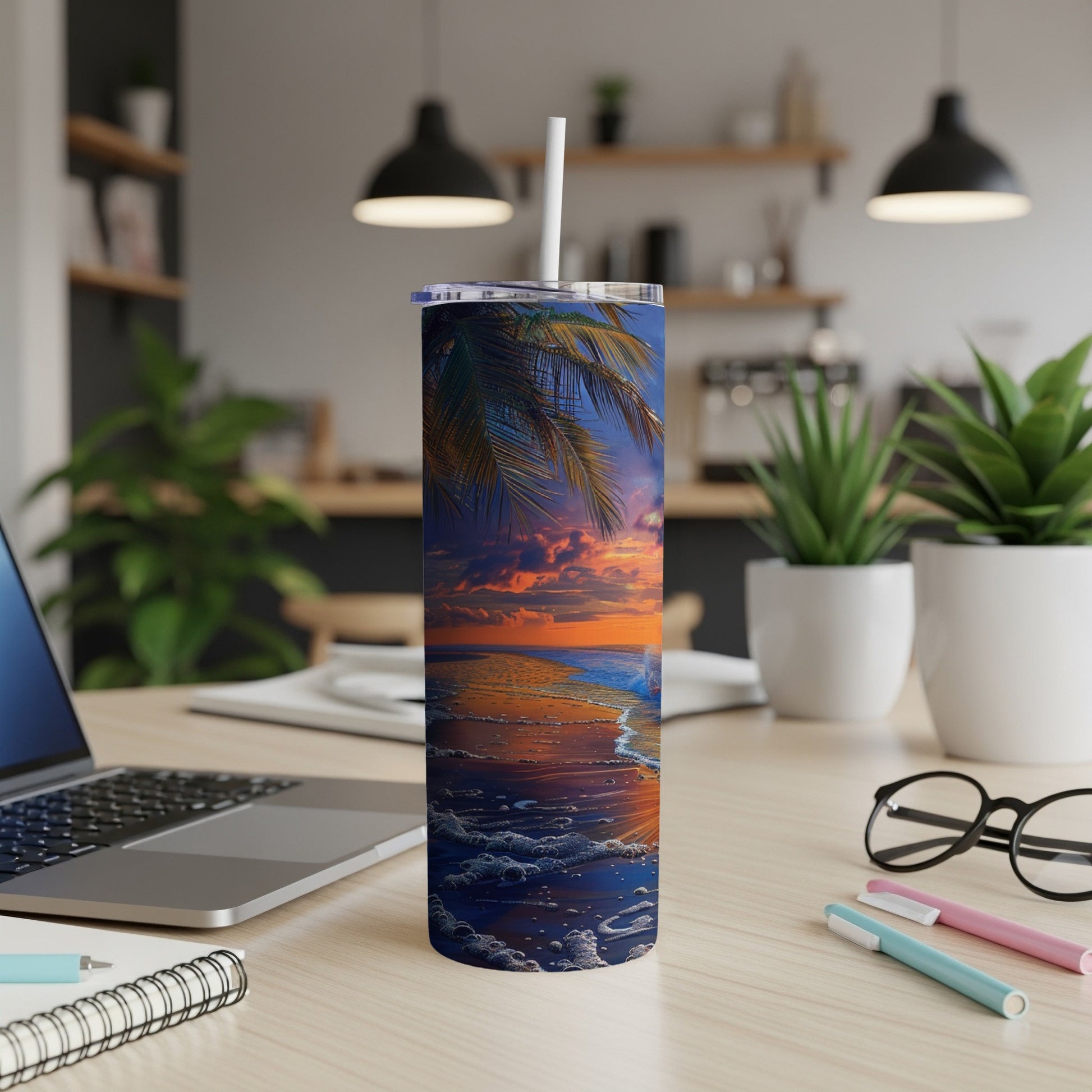 Beach sunset scene on a skinny tumbler with a white straw.