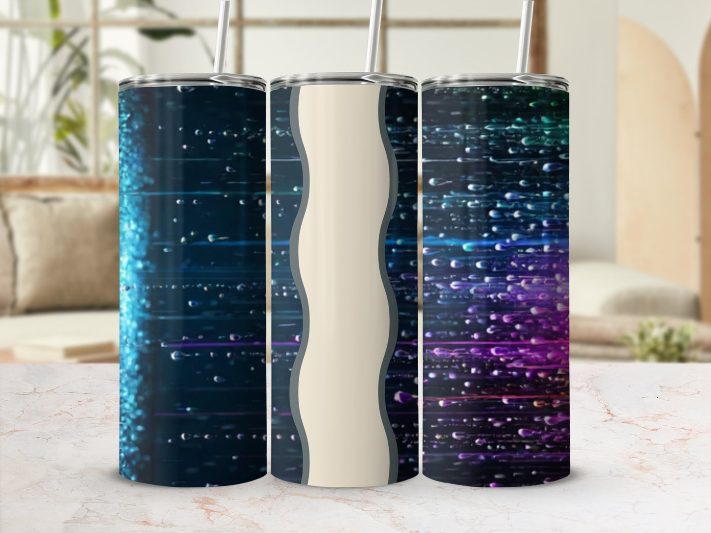 Three insulated tumblers with abstract, colorful, light-streaked designs.