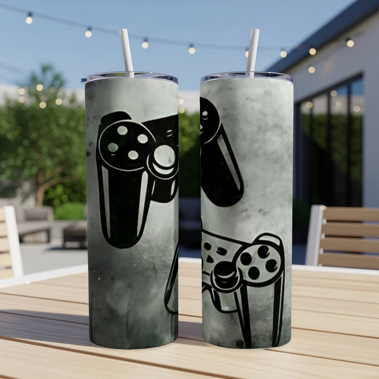 Two tumblers with a black video game controller design on a textured background.