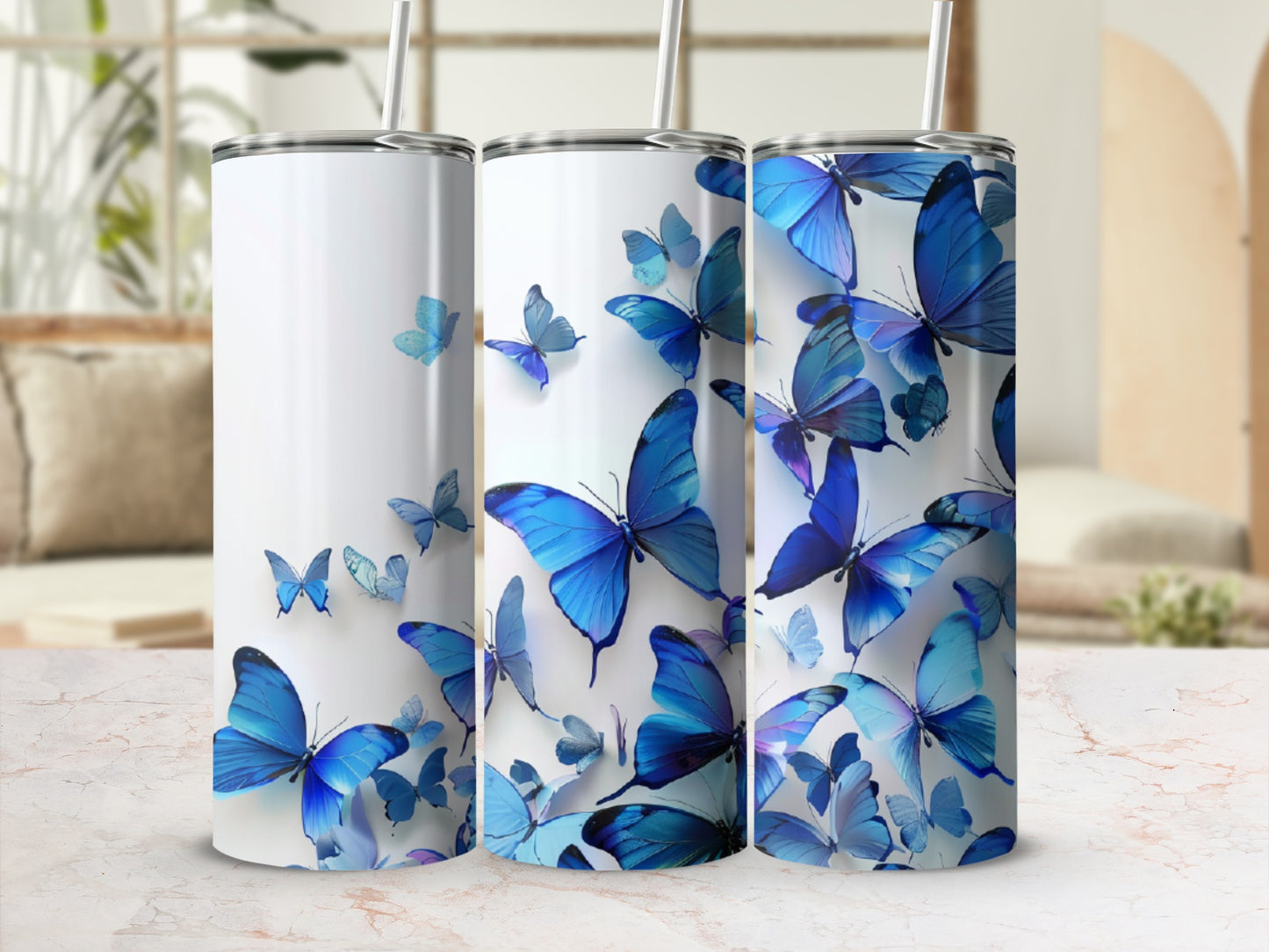 Three tumblers featuring a collage of blue butterflies against a blurred background.