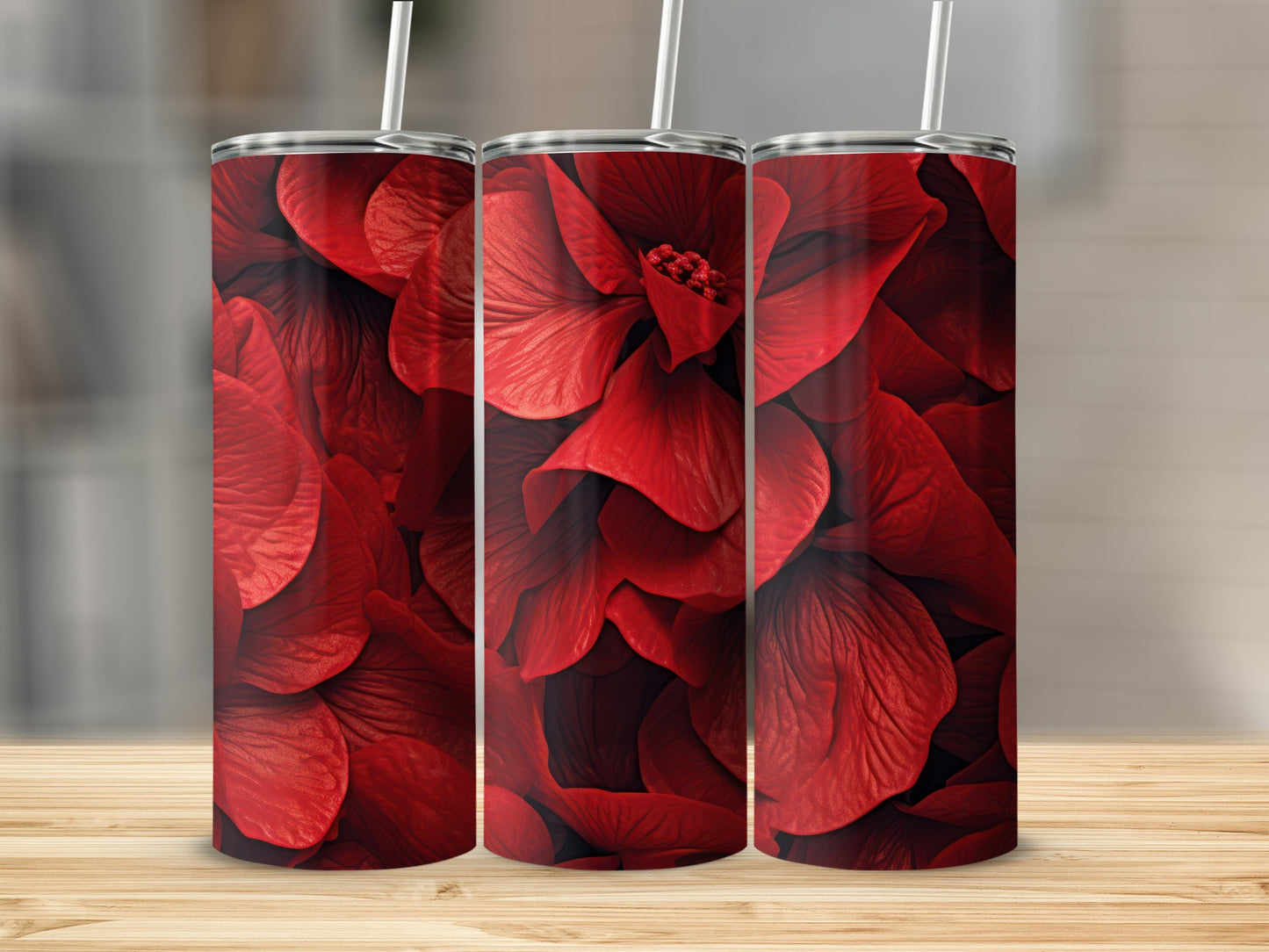 Three tall tumblers with a repeating pattern of red flower petals.