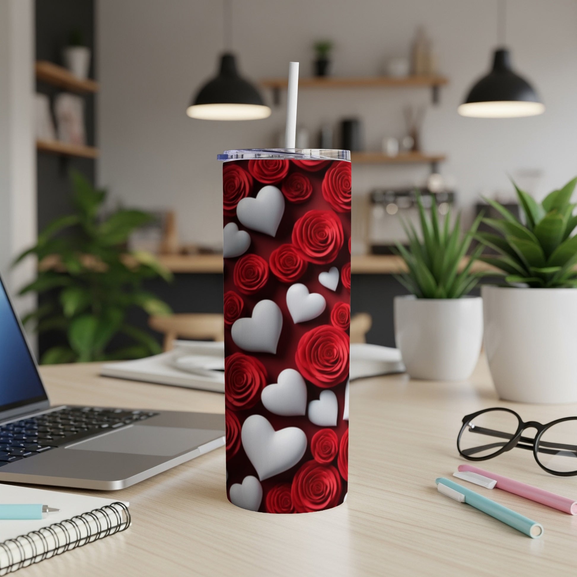 Red roses and white hearts pattern on a stainless steel tumbler.