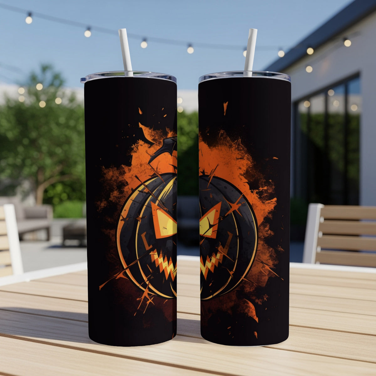 Two black tumblers with cracked jack-o'-lantern design and white straws.