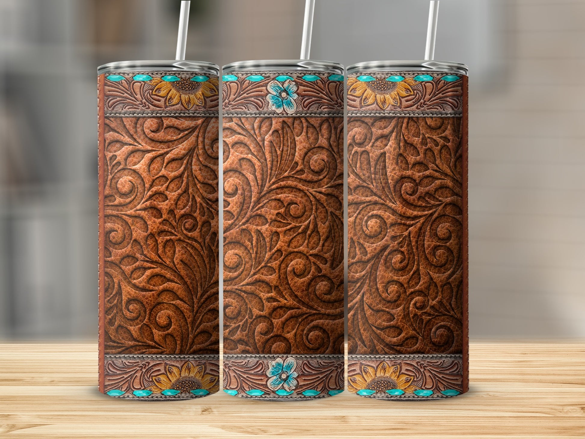Three western-style embossed leather tumblers with sunflowers and turquoise details.