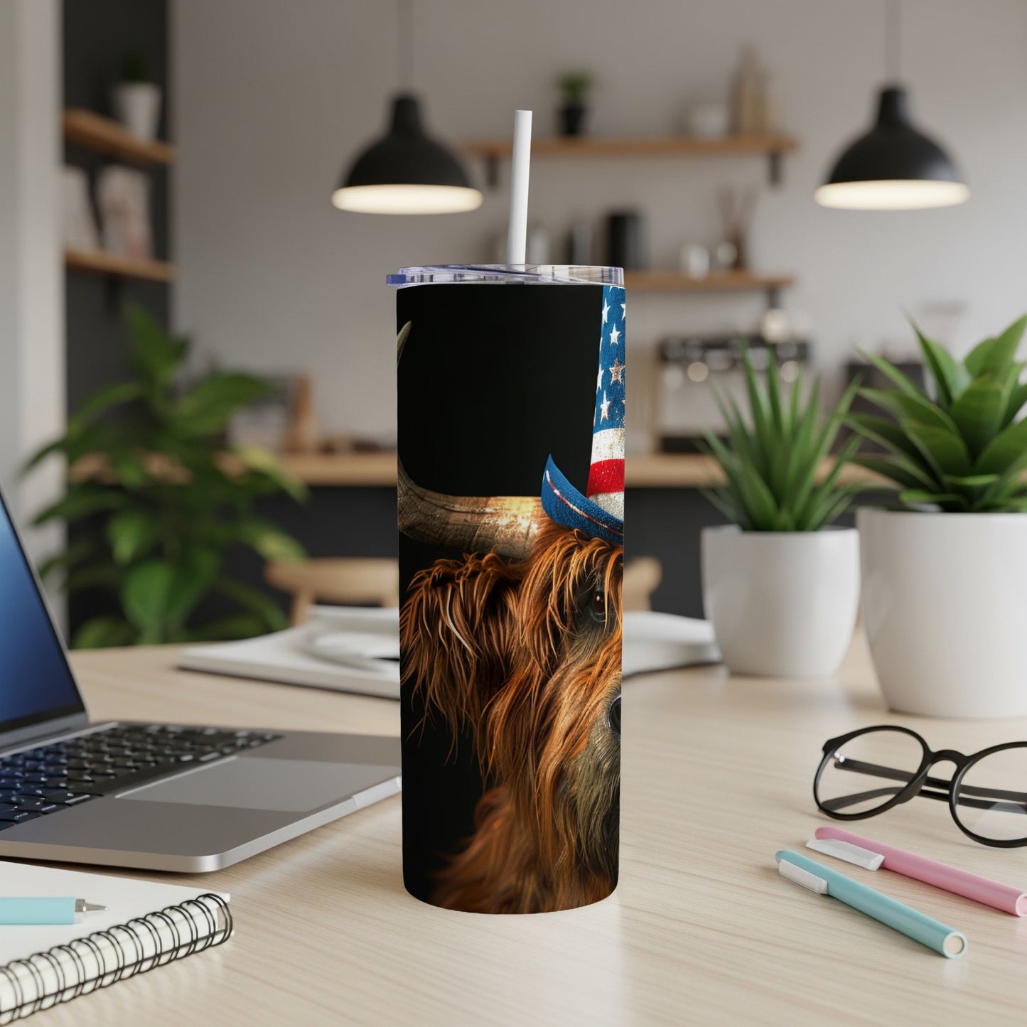 Highland cow wearing patriotic American flag hat and tumbler.