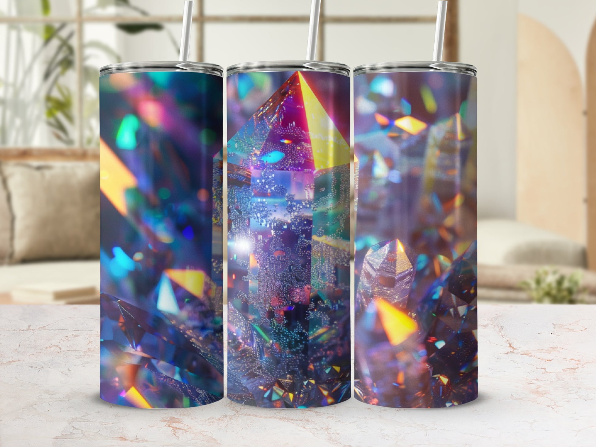 Three tumblers with a holographic crystal design on a marble surface.