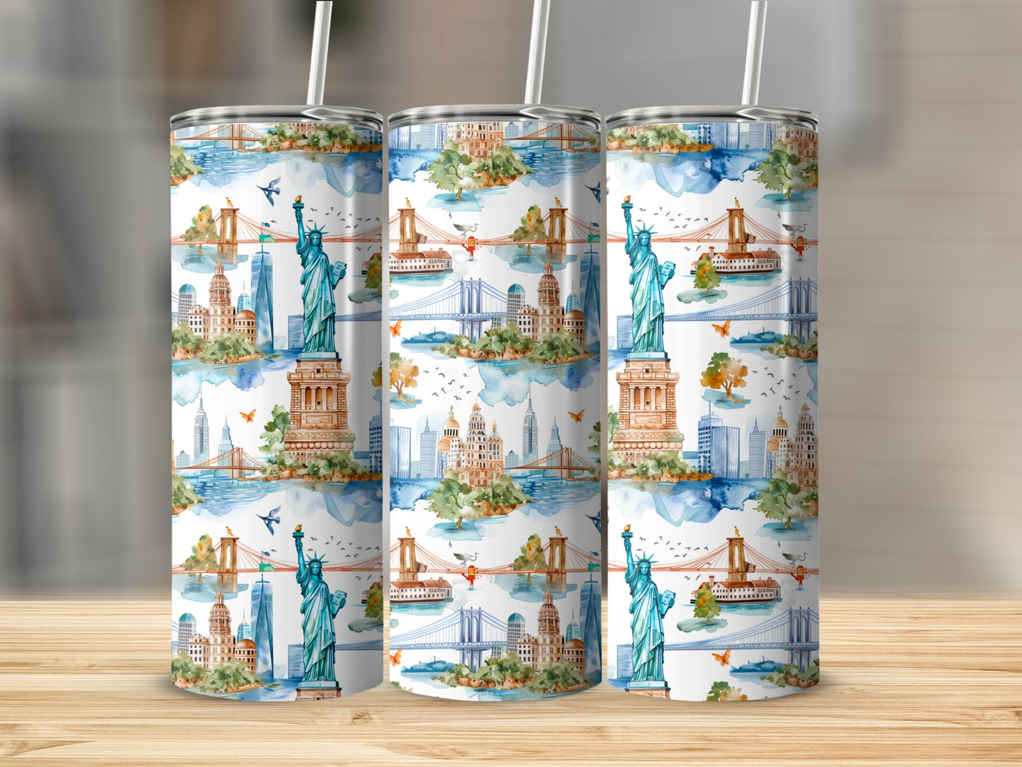 Three tumblers featuring a watercolor New York City skyline with the Statue of Liberty.
