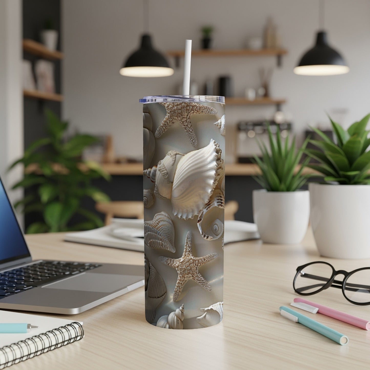 Seashell and starfish pattern on a white tumbler with a straw.