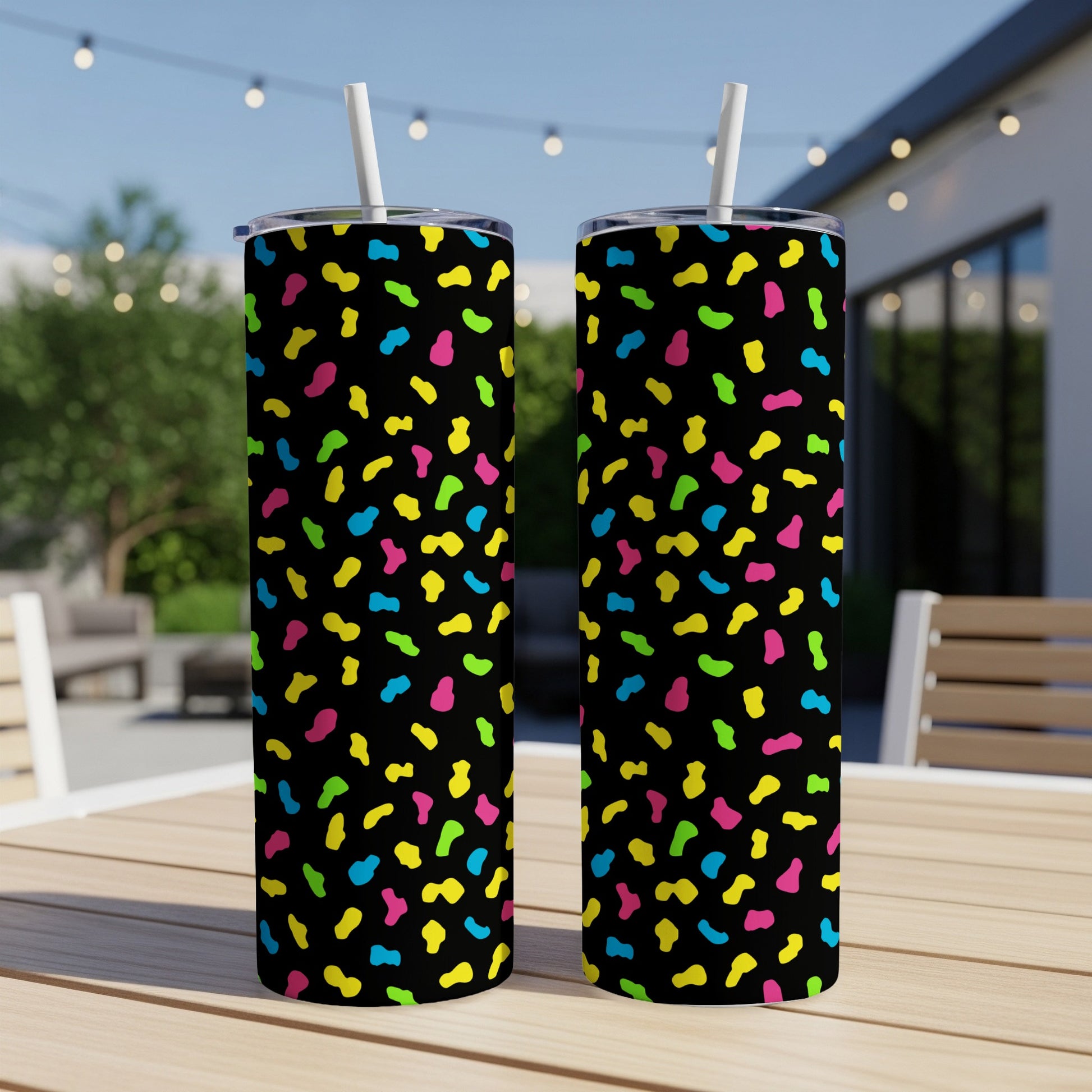 Two tumblers with a black background and colorful confetti pattern.