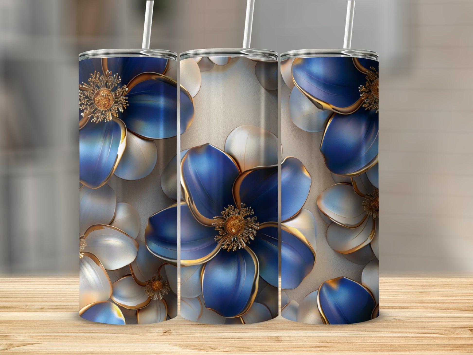 Three tumblers with blue and white floral designs with gold accents.