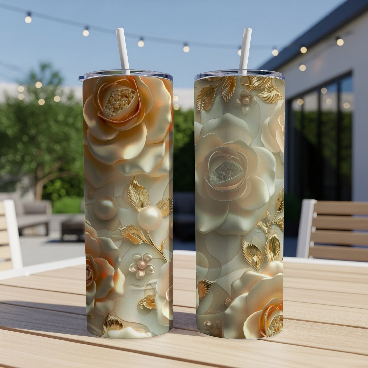 Two tall tumblers with embossed rose and pearl designs on a patio table.