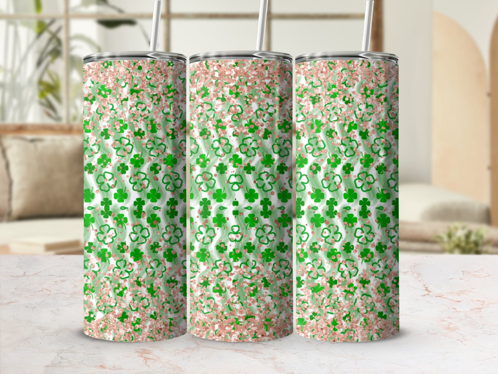 Three tumblers with green clover pattern and rose gold glitter.