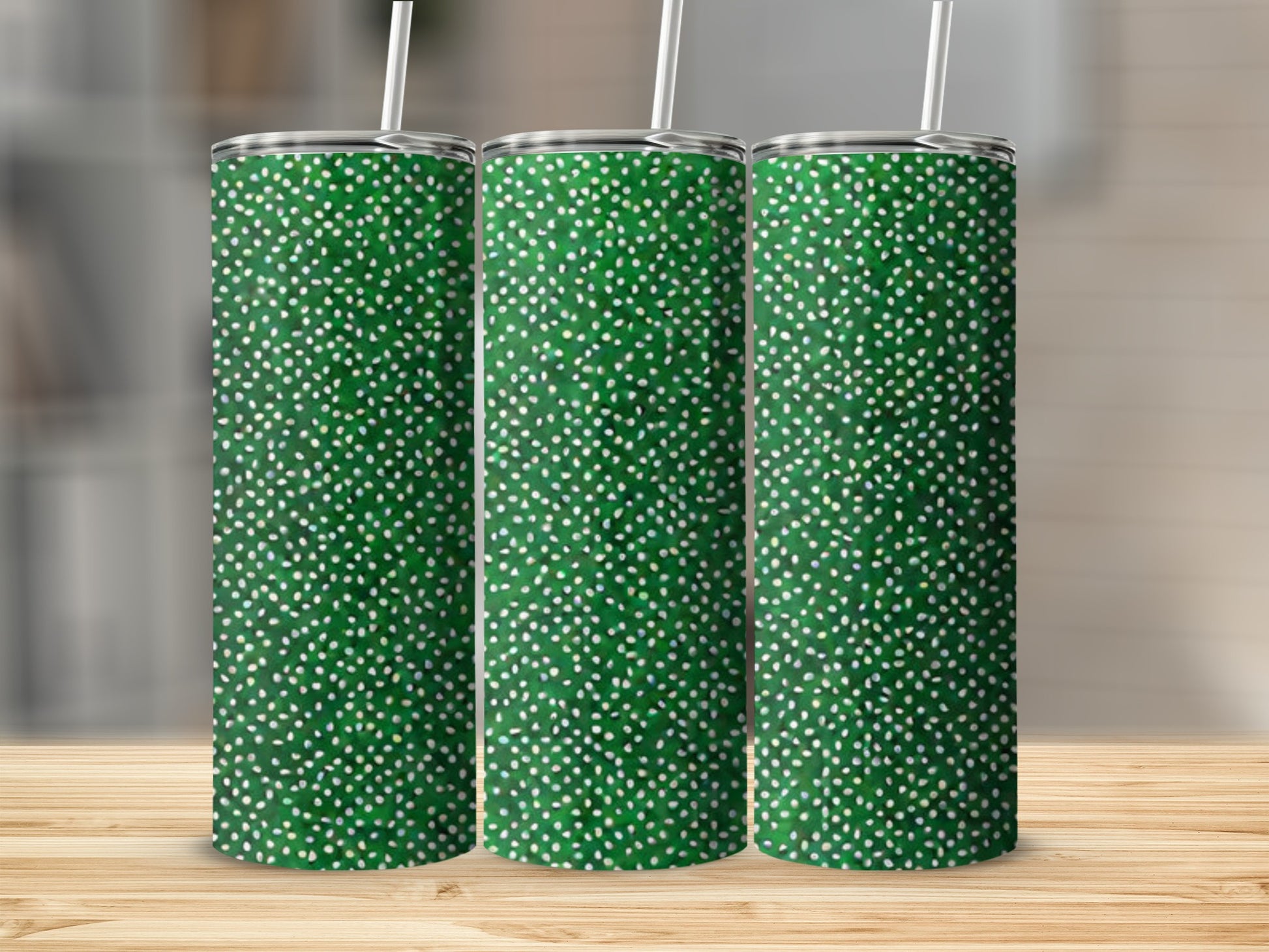 Three green tumblers with white speckled pattern and straws.