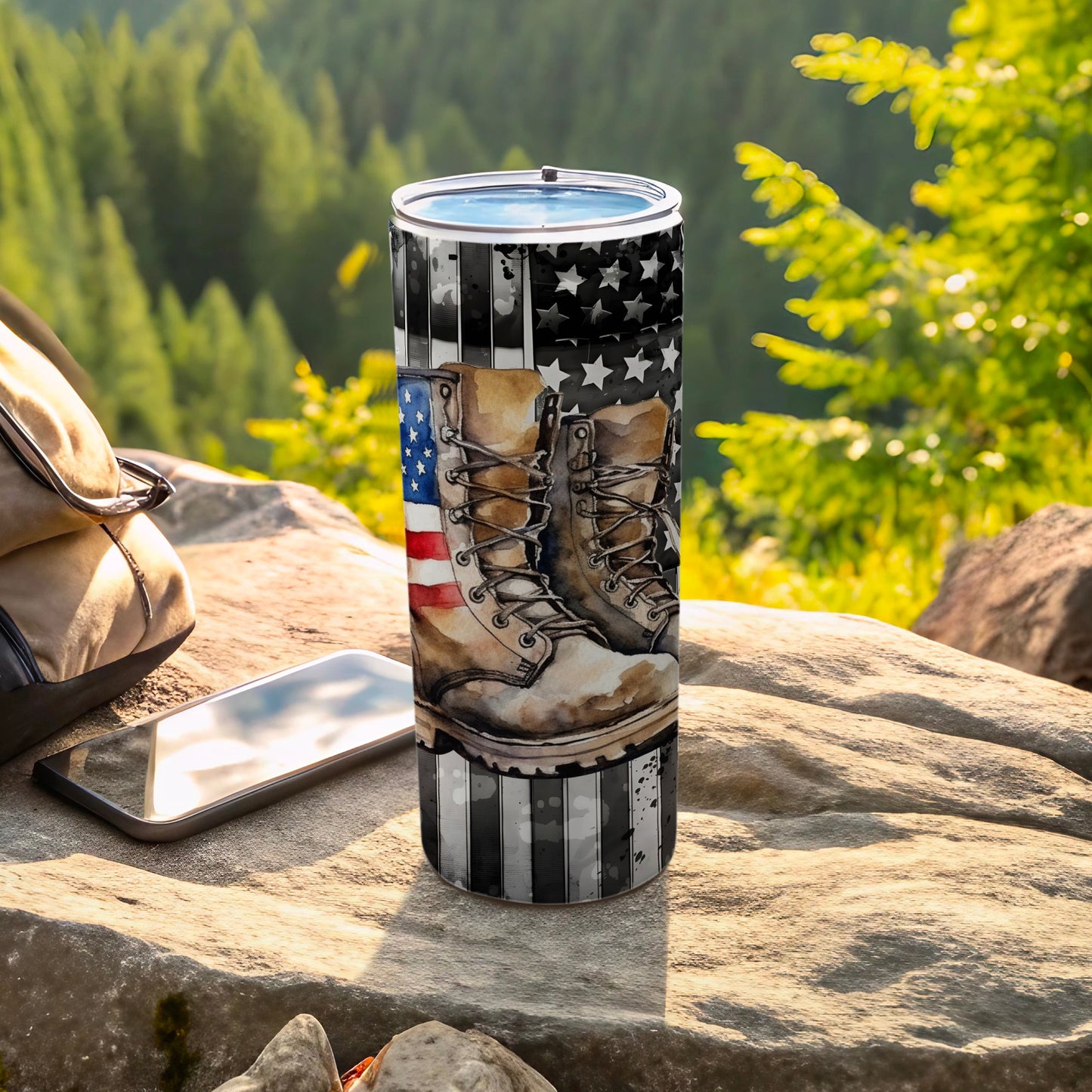 USA flag tumbler with combat boots design on rock.