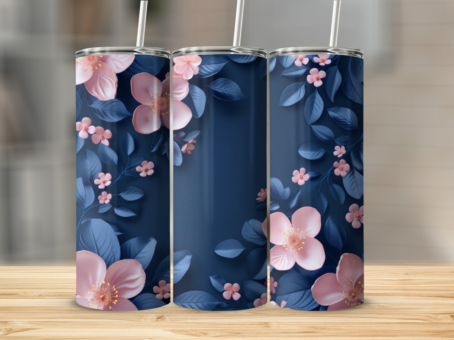 Three navy blue tumblers with pink flowers and green leaves pattern.